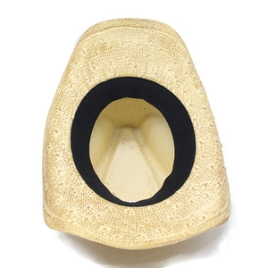 Detail view of woven straw cowboy hat interior showing black sweatband and texture