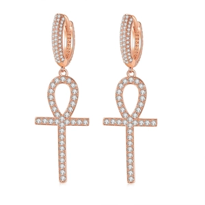 Macro shot of rose gold Ankh cross earrings with micro-pave white zircon stones