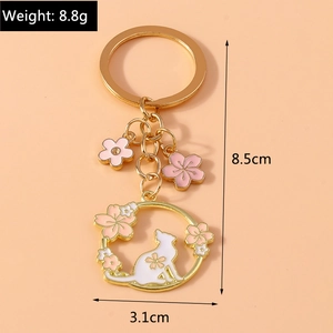Detail view of a floral cat keychain showing 8.5cm length and 8.8g lightweight design