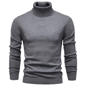 Close-up of ribbed texture on the grey turtleneck sweater's collar and sleeve cuffs