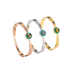 Set of three vintage titanium steel bangles with clover motifs in gold, rose gold and silver