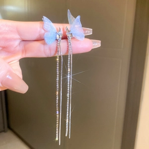 Detail of blue tulle butterfly wing earrings with shimmering long tassel crystal chains