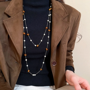 Nahaufnahme einer eleganten doppelreihigen Perlenkette mit braunen Tigerauge-Perlen