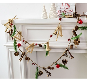 Close-up of rustic Christmas garland with natural pinecones and red berries on white fireplace