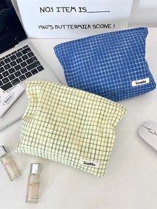 Portable checkered cosmetic bag in blue and yellow gingham fabric with zipper closure