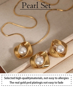 Detail of PVD gold plated pearl jewelry set showing irregular geometric necklace and earrings
