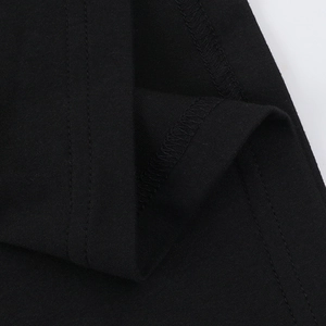 Detailed macro view of black knit fabric texture and high-quality flat seam stitching