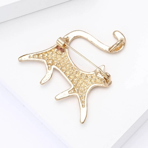 Macro detail of golden cat brooch showing metallic texture and secure back pin closure