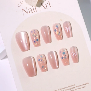 Sparkly nude cat eye press-on nails set with glitter sequins and white bow art