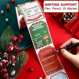 Macro view of hand writing on a Christmas gift label sticker with festive holiday decorations