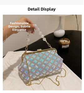 Detail of sequin evening bag featuring pearl handle and gold chain strap close-up