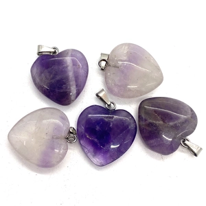 Natural heart-shaped amethyst gemstone pendants with silver bail on white background