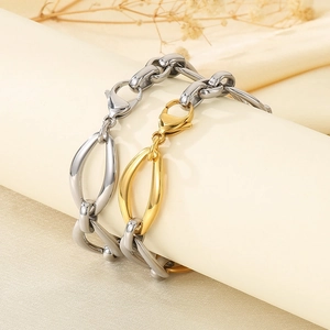 Detail showing oversized two-tone stainless steel link bracelets with lobster clasps