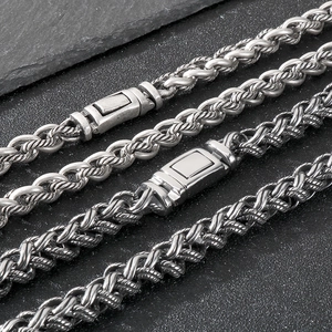 Detailed macro view of woven keel chain links with vintage silver finish and rectangular clasp