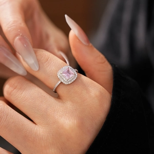 Detailed view of square pink zircon crown ring with double halo setting on finger