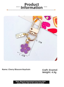 Detailed macro view of purple flower keychain with golden D-ring clasp and size measurements