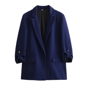 Detailed view of dark blue blazer featuring rolled sleeves and decorative gold cuff buttons