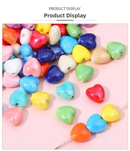 Macro shot of colorful ceramic heart beads for DIY jewelry with glossy glaze finish