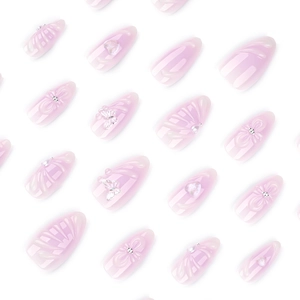 Short almond press-on nails in translucent pink with 3D butterfly and pearl accents