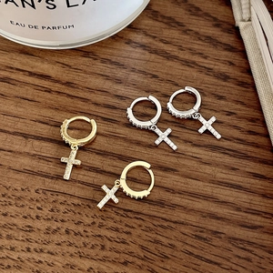 Elegant S925 sterling silver cross drop earrings with white zircon on wooden surface