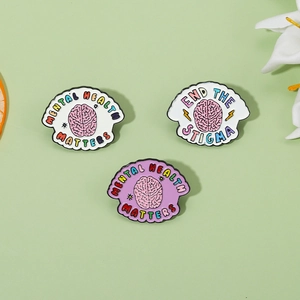 Detailed enamel pins set with mental health slogans and brain illustrations on pastel background