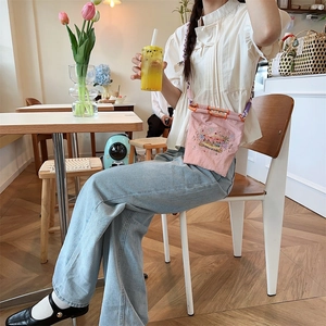 Mini pink canvas bag with colorful flower embroidery and orange ring handle detail