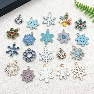 Flat lay of colorful enamel snowflake charms with rhinestones for DIY jewelry making
