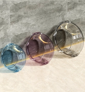 Three clear PET plastic basins in blue, purple, and grey leaning against a marble wall