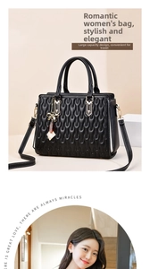 Close-up of black wave quilted tote bag featuring gold hardware and bow accessory