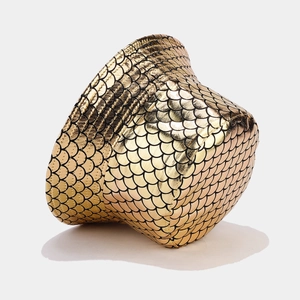 Close-up of metallic gold fish scale texture on a reversible bucket hat for women