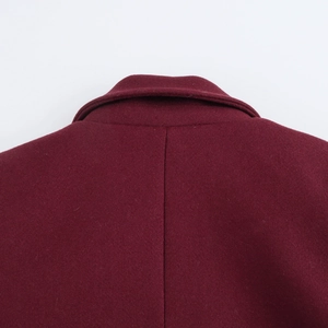Macro shot of the wine red wool coat collar showing fabric texture and premium stitching