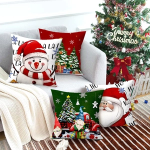 Set of 4 Christmas pillow cases with Gnome and Santa motifs on a cozy grey sofa