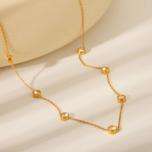 Detail of 18K gold-plated stainless steel chain with round bezel-set zircon stones