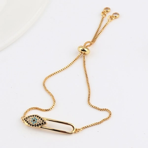Detail of gold safety pin bracelet with micro-paved colored zircons and evil eye motif