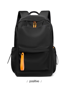 Detail view of black oxford backpack with orange zipper accents and breathable mesh straps