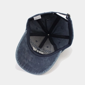 Vintage washed navy blue cotton baseball cap with internal embroidery and metal buckle