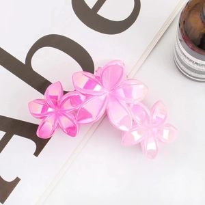 Detail of pink pearlescent flower hair claw clip with matte finish on floral patterns