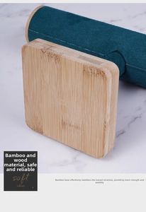Close-up of bamboo wood base and teal velvet roll for jewelry bracelet display