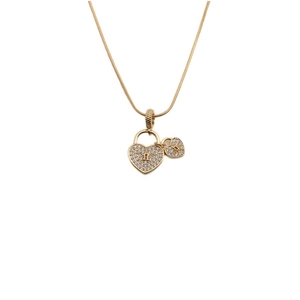 Gold-tone heart lock pendant necklace with cubic zirconia accents on a white background