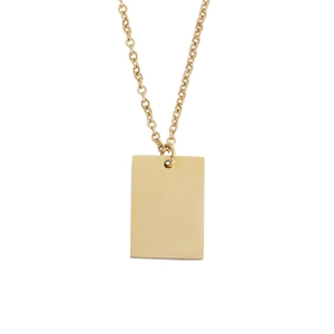 Macro shot of polished gold rectangle pendant on a classic chain necklace