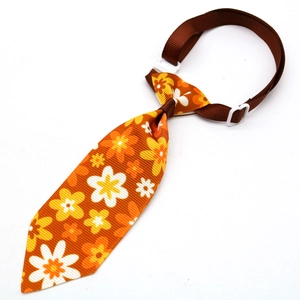 Adjustable floral pet tie with orange flower print and secure buckle for cats and small dogs