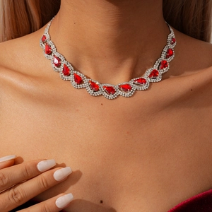 Detailed view of luxury necklace set featuring pear-cut red gems and sparkling diamonds