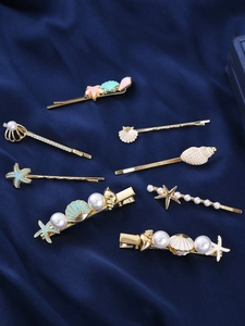 Detailed set of 8 gold ocean-themed hair clips with starfish, shells and pearls
