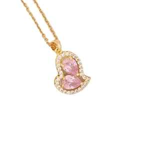 Pink heart pendant necklace in gold finish with sparkling crystals on white background