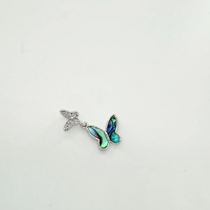 Detail of silver butterfly pendant with abalone shell and sparkling crystals