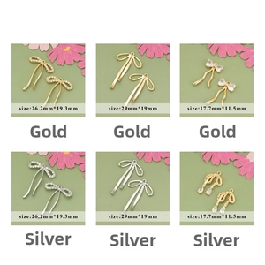 Detail of 18k gold plated bow charms with zircon stones in various styles and sizes