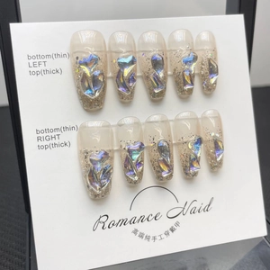 Handmade nude press-on nails with aurora heart crystals and silver glitter in long coffin shape