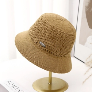 Hollow knit bucket hat for women in mustard yellow with a sleek metal logo plate detail