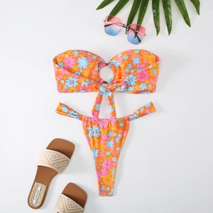 Close-up of floral print bikini with central ring detail and vibrant summer accessories