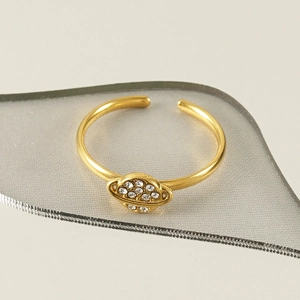 Detailed macro view of 18k gold adjustable Saturn ring with sparkling crystal inlay